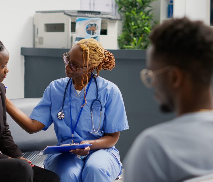Medical nurse doing consultation with patient in waiting area, showing checkup forms to explain disease diagnosis. Health specialist trying to help woman with medication, exam clinic.